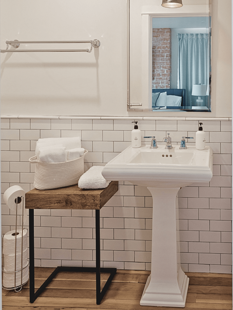 For spaces like a pedestal sink, which doesn't allow for much counter space, incorporate other cabinets with surface area to make getting ready easier.